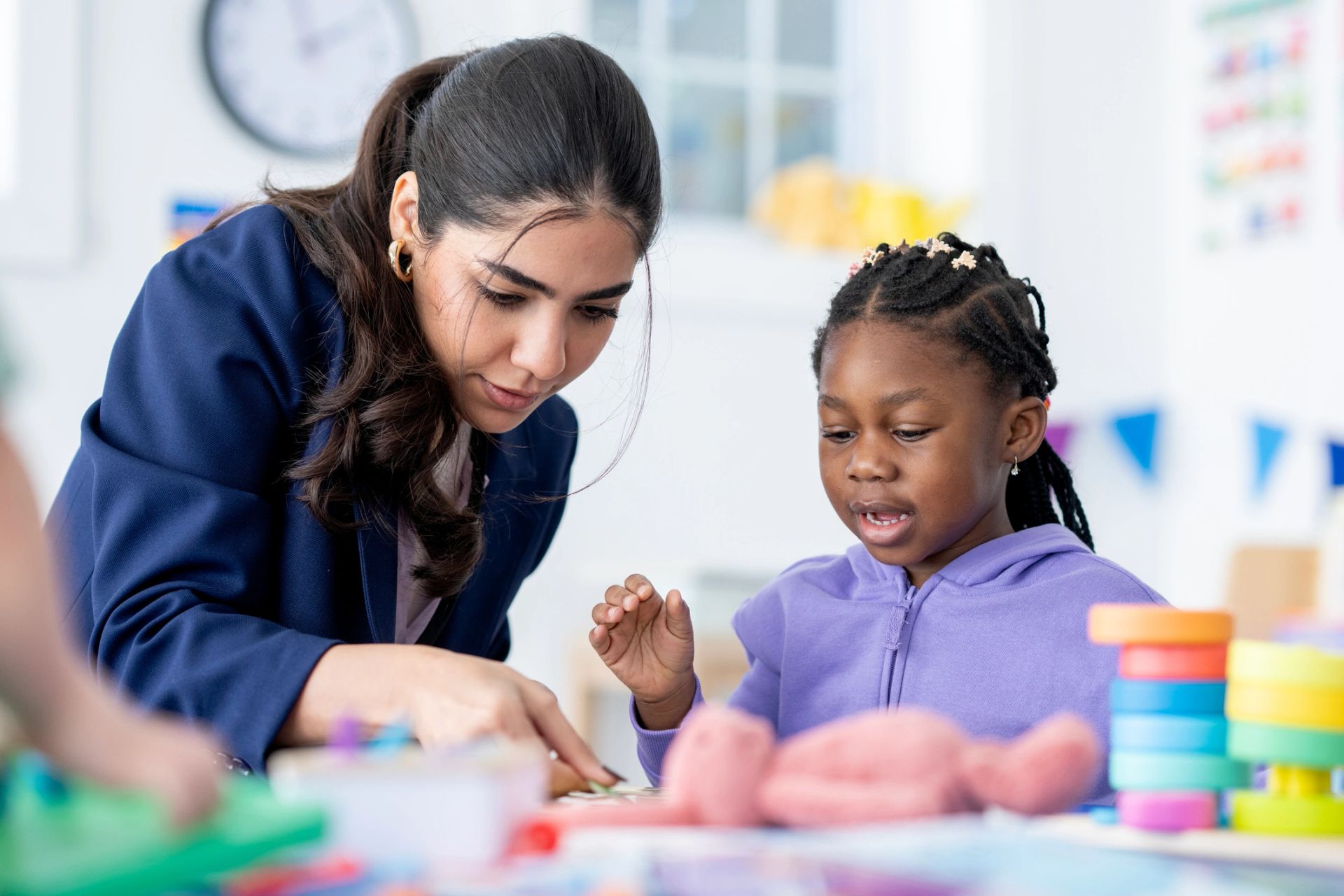 Adult and child playing with colorful manipulatives, the preserved first Stubby's homepage image